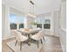 Bright dining room with a wood table, white chairs, and large windows at 13026 Arnold Palmer Cir # 1051, Lancaster, SC 29720