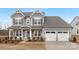 Two-story house with gray siding, white trim, and a two-car garage at 13026 Arnold Palmer Cir # 1051, Lancaster, SC 29720