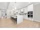 Modern kitchen featuring white cabinets, a large island, and stainless steel appliances at 13026 Arnold Palmer Cir # 1051, Lancaster, SC 29720