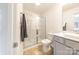 Well-lit bathroom with a glass-enclosed shower and stylish gray vanity with solid surface countertop at 3035 Howell Mill Rd # 51, Charlotte, NC 28208