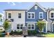 Charming townhome showcases a blue and white exterior with well-maintained landscaping at 3035 Howell Mill Rd # 51, Charlotte, NC 28208