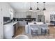 Well-lit kitchen featuring gray cabinetry, stainless steel appliances, island with seating, and modern fixtures at 3035 Howell Mill Rd # 51, Charlotte, NC 28208