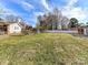 Spacious backyard with chain link fence and mature trees at 5301 Hughes Dr, Charlotte, NC 28213