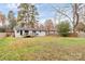 Spacious backyard with large grassy area and wooden deck at 5442 Kinsale Ln, Charlotte, NC 28215