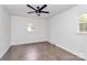 Spacious bedroom with dark hardwood floors and ceiling fan at 5442 Kinsale Ln, Charlotte, NC 28215