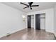 Bedroom with double closets, dark hardwood floors, and ceiling fan at 5442 Kinsale Ln, Charlotte, NC 28215