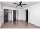 Bedroom with double closets, dark hardwood floors and ceiling fan at 5442 Kinsale Ln, Charlotte, NC 28215