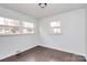 Well-lit bedroom featuring dark hardwood floors at 5442 Kinsale Ln, Charlotte, NC 28215