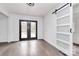 Bright dining room featuring hardwood floors, french doors, and a modern barn door at 5442 Kinsale Ln, Charlotte, NC 28215