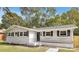 Charming ranch home with white brick exterior, black shutters, and landscaped lawn at 5442 Kinsale Ln, Charlotte, NC 28215