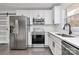 Renovated kitchen with stainless steel appliances and white cabinetry at 5442 Kinsale Ln, Charlotte, NC 28215