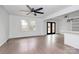 Spacious living room with hardwood floors, ceiling fan, and access to rear deck at 5442 Kinsale Ln, Charlotte, NC 28215