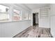 Sunroom with built-in shelving, wood-look floors, and multiple windows at 5442 Kinsale Ln, Charlotte, NC 28215