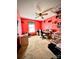 Red-walled bedroom used as an office with built-in shelving at 6219 Long Pine Dr # 32, Charlotte, NC 28227