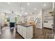 Open concept kitchen with island, stainless steel appliances, and hardwood floors at 8620 Miles Gap Rd, Indian Land, SC 29707