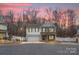 Two-story house with gray siding, a white garage door, and a basketball hoop at 910 Mibbs Pl, Statesville, NC 28625