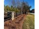 Landscaped area with a wooden fence and stone pillars at 1063 Horizon Ln, Chester, SC 29706