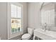 Small bathroom with white sink, toilet and window with shutters at 1076 Fox Chase Dr, Newton, NC 28658