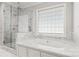 Spa-like bathroom with soaking tub, walk-in shower, and marble finishes at 1076 Fox Chase Dr, Newton, NC 28658