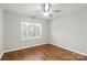 Bright bedroom with hardwood floors, window with shutters, and ceiling fan at 1076 Fox Chase Dr, Newton, NC 28658