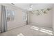 Bright bedroom featuring a floral wall accent and plantation shutters at 1103 Hulston Ct, Charlotte, NC 28211