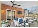 Relaxing covered deck with seating area and brick wall at 1103 Hulston Ct, Charlotte, NC 28211