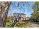 Two-story brick house with mature trees and a paved driveway at 1103 Hulston Ct, Charlotte, NC 28211