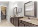 Bathroom with dual sinks, granite counters, dark cabinetry, and tiled floors at 1209 Cedar Park Dr, Pineville, NC 28134