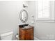 Elegant bathroom features a wood vanity, decorative mirror, and classic fixtures at 1209 Cedar Park Dr, Pineville, NC 28134