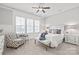 Bright bedroom showcases a ceiling fan and large windows for plenty of natural light at 1209 Cedar Park Dr, Pineville, NC 28134