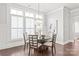 Bright dining room features bright windows, and an elegant chandelier at 1209 Cedar Park Dr, Pineville, NC 28134