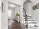 Inviting entryway features staircase, dark wood floors, and a decorative cabinet with lamps at 1209 Cedar Park Dr, Pineville, NC 28134