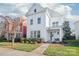 Charming two-story white home with manicured front yard landscaping and welcoming entryway at 1209 Cedar Park Dr, Pineville, NC 28134