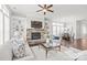 Open living space with stone fireplace, built-ins, and view to the adjacent dining area at 1209 Cedar Park Dr, Pineville, NC 28134