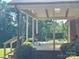 Relaxing back porch featuring comfortable seating and views of the landscaped backyard at 16480 Indian Mound Rd, Norwood, NC 28128