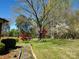 Backyard with mature trees, garden beds and a stepping stone pathway at 16480 Indian Mound Rd, Norwood, NC 28128