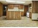 Spacious basement kitchen with wood cabinets and an island at 16480 Indian Mound Rd, Norwood, NC 28128