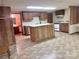 Basement kitchen with a central island and white appliances at 16480 Indian Mound Rd, Norwood, NC 28128