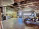 Unfinished basement featuring a garage door with exposed beams and shelving at 16480 Indian Mound Rd, Norwood, NC 28128