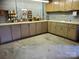 Basement featuring painted cinderblock walls, utility sink, and ample storage cabinets at 16480 Indian Mound Rd, Norwood, NC 28128