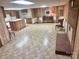 Finished basement with tile flooring, wood paneling, kitchen and brick fireplace at 16480 Indian Mound Rd, Norwood, NC 28128