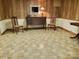 Finished basement with tile flooring, wood paneling, kitchenette and furniture at 16480 Indian Mound Rd, Norwood, NC 28128