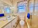 Bathroom with shower, toilet, vanity, and window view at 16480 Indian Mound Rd, Norwood, NC 28128