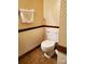 Small bathroom with toilet and patterned wallpaper at 16480 Indian Mound Rd, Norwood, NC 28128