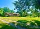 Charming brick home with a well-manicured front yard and a welcoming porch entrance at 16480 Indian Mound Rd, Norwood, NC 28128
