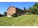 Brick house with attached garage, covered porch, and well-maintained lawn at 16480 Indian Mound Rd, Norwood, NC 28128
