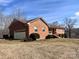 Brick ranch house with attached garage and landscaped yard at 16480 Indian Mound Rd, Norwood, NC 28128