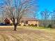 Brick ranch house nestled on a large lot with trees at 16480 Indian Mound Rd, Norwood, NC 28128