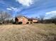 Ranch house with a large grassy yard and trees at 16480 Indian Mound Rd, Norwood, NC 28128