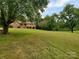 Ranch house with a spacious lawn and mature trees at 16480 Indian Mound Rd, Norwood, NC 28128